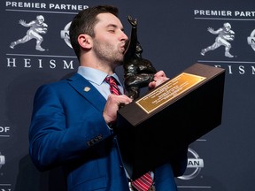 In this Dec. 9, 2017, file photo, Oklahoma quarterback Baker Mayfield kisses the Heisman Trophy in New York. (AP Photo/Craig Ruttle, File)