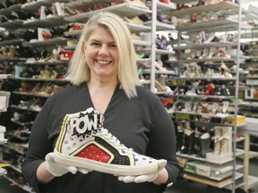 Senior Curator Elizabeth Semmelhack holds one of thousands of shoes that are housed in the Bata Shoe Museum on Friday April 20, 2018.
