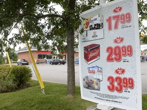 Beer is advertised for sale outside a store in Drummondville, Que., on Thursday, July 23, 2015.