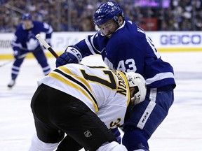 Boston Bruins Patrice Bergeron (37) wins a draw against Maple Leafs Nazem Kadri during the first period in Toronto on Monday April 23, 2018. (Jack Boland/Toronto Sun)