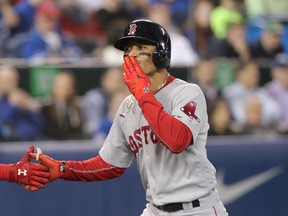 Mookie Betts of the Boston Red Sox celebrates after hitting a  home run against the Jays last night. (Getty Images)