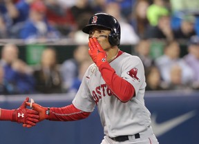 Mookie Betts of the Boston Red Sox celebrates after hitting a  home run against the Jays last night. (Getty Images)