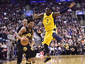 Toronto Raptors guard Kyle Lowry (7) moves past a leaping Indiana Pacers guard Darren Collison (2) during first half NBA basketball action in Toronto on Friday, April 6, 2018.