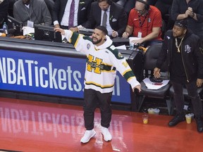 Rapper Drake wears a Humboldt Broncos jersey during second half round one NBA playoff basketball action as the Toronto Raptors play against the Washington Wizards in Toronto on Saturday, April 14, 2018.
