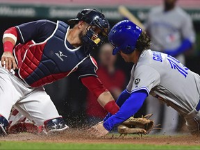 Cleveland Indians' Yan Gomes tags out Toronto Blue Jay's Randal Grichuk during the seventh inning of Friday's game in Cleveland. The teams were rained out on Saturday. (AP Photo/David Dermer)