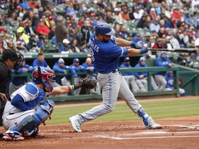 Toronto Blue Jays' Kendrys Morales (8) follows through on his three-run home run in front of Texas Rangers catcher Robinson Chirinos, left, during the first inning of a baseball game, Sunday, April 8, 2018, in Arlington, Texas. (AP Photo/Jim Cowsert) ORG XMIT: ARL110