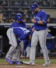 Toronto Blue Jays designated hitter Kendrys Morales, right, crosses home plate as Teoscar Hernandez pulls off his shin guard after taking a walk with the bases loaded against the New York Yankees during the fifth inning of a baseball game, Friday, April 20, 2018, in New York. (AP Photo/Julie Jacobson) ORG XMIT: NYJJ117