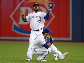 Teoscar Hernandez of the Toronto Blue Jays catches a fly ball as Devon Travis gets out of his way against the Texas Rangers at Rogers Centre on April 27, 2018 in Toronto. (Tom Szczerbowski/Getty Images)