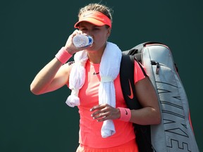 Eugenie Bouchard walks off court after losing to Rebecca Peterson during the Miami Open at Crandon Park Tennis Center on March 20, 2018