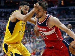 Indiana Pacers guard Cory Joseph hits Washington Wizards guard Tomas Satoransky in the face as he drives with the ball during NBA action on March 17, 2018