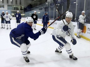 Toronto Maple Leafs Connor Brown (28) and teammate William Nylander curl into the corner during a recent practice in Toronto. (Jack Boland/Toronto Sun)