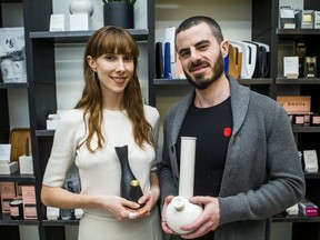 Tokyo Smoke's Ljubica Kostovic and Josh Lyon pose for a photo holding bongs at the coffee shop along Queen St. W. on Wednesday April 18, 2018.