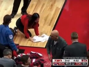 ACC workers mop up spilled beer on the court during the Raptors-Wizards game on Tuesday, April 17, 2018. (Screengrab)