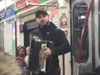 A local busker with accordion jumps from subway car to subway car playing ‘Despacito.’ Screengrab