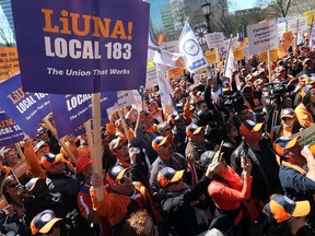 Members of LiUNA, the union representing construction labourers in Ontario gather outside Queen's Park in Toronto in protest of the provincial government's budget legislation, labour law changes known as Schedule 14 that they say give the Carpenter's Union an advantage at their expense on Monday April 23, 2018.