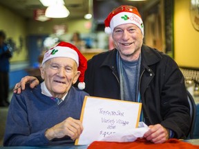 Mort Greenberg (left) presents a cheque at Zupa's Deli to Toronto Sun columnist Mike Strobel for his Christmas Fund in Toronto, Ont. on December 21, 2016. Ernest Doroszuk/Toronto Sun