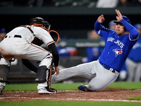 Toronto Blue Jays' Aledmys Diaz, right, is out at the plate against Baltimore Orioles catcher Caleb Joseph, left, during the eighth inning of a baseball game, Monday, April 9, 2018, in Baltimore. (AP Photo/Nick Wass)