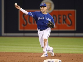 Aledmys Diaz of the Toronto Blue Jays makes a throwing error in the fifth inning during MLB game action against the Chicago White Sox at Rogers Centre on April 3, 2018