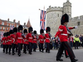Soldiers from the Queen’s Guard prepare for the ‘Changing of the Guard’ ceremony at Windsor Castle, where the royal wedding of Prince Harry and Meghan Markle will take place. ANDREW COWIE/GETTY IMAGES