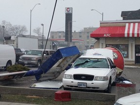 A KFC bucket sign collapses on a taxi in Hamilton due to high 90 km/h winds on Wednesday afternoon.