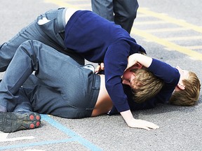 Two Boys Fighting In School Playground