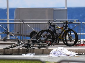 Bicycles, a shoe and sheets lay at the scene where a truck mowed through revelers in Nice, southern France, Friday, July 15, 2016.  A large truck mowed through revelers gathered for Bastille Day fireworks in Nice, killing more than 80 people and sending people fleeing into the sea as it bore down for more than a mile along the Riviera city's famed waterfront promenade.  (AP Photo/Francois Mori)