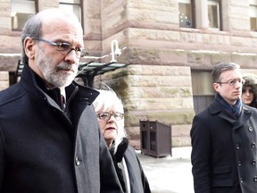 David Livingston, left, leaves court with supporters in Toronto, Friday, Jan.19, 2018. A one-time top political aide is set to find out his punishment today for destroying computer records related to Ontario's gas-plants fiasco.