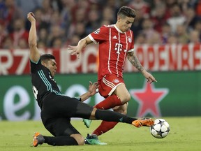 Real Madrid's Casemiro, left, and Bayern's James challenge for the ball at the Allianz Arena stadium in Munich Wednesday, April 25, 2018.