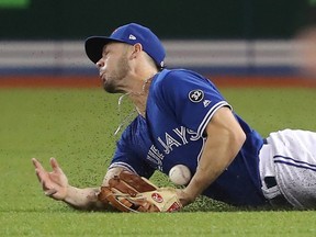 Randal Grichuk of the Toronto Blue Jays makes a sliding catch in the first inning at Rogers Centre on April 29, 2018. (TOM SZCZERBOWSKI/Getty Images)