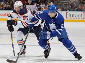 Connor McDavid of the Edmonton Oilers skates after a puck against Ron Hainsey of the Toronto Maple Leafs at the Air Canada Centre on December 10, 2017 in Toronto. (Claus Andersen/Getty Images)