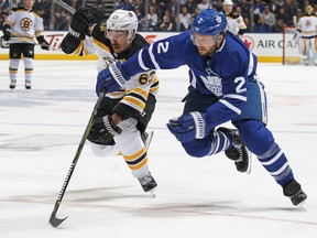 Ron Hainsey and Brad Marchand race for the puck during Game 6 on April 23, 2018