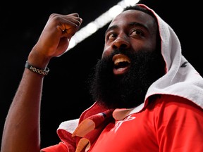 Houston Rockets guard James Harden gestures to a fan who was heckling him during the second half of the team's NBA basketball game against the Los Angeles Lakers on April 10, 2018