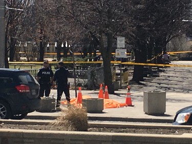 An orange tarp covers a body on Yonge St. after a van ran down pedestrians on April 23, 2018. (Stan Behal/Toronto Sun)