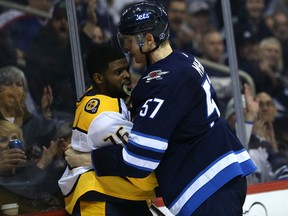 Winnipeg Jets defenceman Tyler Myers pins Nashville Predators defenceman P.K. Subban to the boards in Winnipeg on March 25, 2018