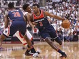 John Wall of the Washington Wizards dribbles past Kyle Lowry of the Toronto Raptors during Game 1 of the first round of the playoffs at the Air Canada Centre on April 14, 2018