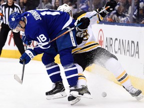 Toronto Maple Leafs left winger Andreas Johnsson battles Boston Bruins defenceman Kevan Miller for control of the puck during Game 4 on April 19, 2018