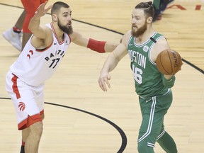Toronto Raptors centre Jonas Valanciunas and Boston Celtics centre Aron Baynes during an NBA game in Toronto on April 4, 2018