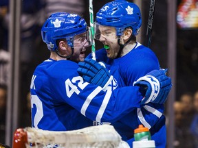 Toronto Maple Leafs forwards James van Riemsdyk and Tyler Bozak celebrate a goal in Game 3 against the Boston Bruins at the Air Canada Centre on April 16, 2018