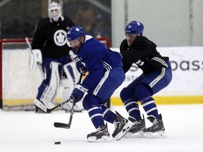 Toronto Maple Leafs forward Nazem Kadri is checked by defenceman Jake Gardiner during practice in Toronto on April 18, 2018