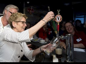Ontario Liberal Leader Kathleen Wynne pulls a beer at a campaign event in Sudbury on May 27, 2014.