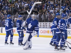 Toronto Maple Leafs goaltender Frederik Andersen (centre) raises his stick to acknowledge fans as the Maple Leafs leave the ice after defeating the Montreal Canadiens in NHL hockey action in Toronto, on Saturday, April 7, 2018. THE CANADIAN PRESS/Chris Young