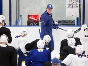 Toronto Maple Leafs head coach Mike Babcock talks to his players during a practice session in Toronto on April 9, 2018, as the team prepares for their opening playoff round against the Boston Bruins