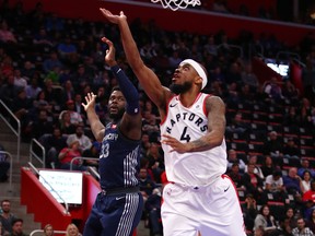 Lorenzo Brown of the Toronto Raptors gets to the basket next to James Ennis III of the Detroit Pistons during an NBA game on April 9, 2018