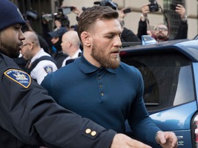 Ultimate fighting star Conor McGregor heads to a vehicle to leave Brooklyn Criminal Court on April 6, 2018 in New York