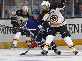 William Nylander of the Toronto Maple Leafs skates between Patrice Bergeron and Brad Marchand of the Boston Bruins during Game 3 at the Air Canada Centre on April 16, 2018