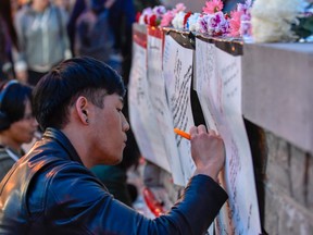 People leave messages of condolence at a makeshift memorial near Yonge and Finch on April 23, 2018 after the van attack. (EXimages/WENN.com)