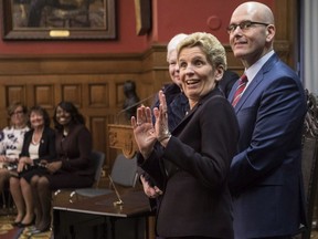 Ontario Premier Kathleen Wynne hams for the cameras as she stands next to newly appointed Minister of Economic Development and Growth, Steven Del Duca, during a swearing-in ceremony following a Cabinet Shuffle at the Ontario Legislature in Toronto on Wednesday, January 17, 2018. (Chris Young/THE CANADIAN PRESS)