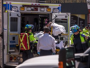A injured person is put into the back of an ambulance in Toronto after a van mounted a sidewalk crashing into a number of pedestrians on Monday, April 23, 2018.