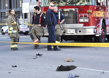 Shoes lay in the street as first responders secure the area in Toronto after a van mounted a sidewalk crashing into a number of pedestrians on Monday, April 23, 2018. THE CANADIAN PRESS/Nathan Denette