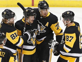 The Pittsburgh Penguins celebrate a goal during the first period of an NHL hockey game against the Ottawa Senators on Feb. 13, 2018